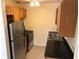 Efficient kitchen with stainless steel appliances, wooden cabinets, and practical countertops at 530 Ruffel St, Maitland, FL 32751