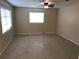 Bright living room with neutral walls, ceiling fan, and large window providing ample natural light at 530 Ruffel St, Maitland, FL 32751