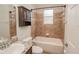 This bathroom features a vanity sink, cabinet storage, a toilet, and a tub and shower combo at 543 Auburn Hill Blvd, Auburndale, FL 33823