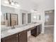 Primary bathroom with dual sinks, granite countertops, and separate tub and shower, offering a spa-like experience at 543 Auburn Hill Blvd, Auburndale, FL 33823