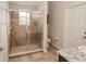 The bathroom features a glass enclosed shower, granite vanity, tiled floors, and a toilet at 543 Auburn Hill Blvd, Auburndale, FL 33823