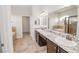 Bathroom with dual sinks, granite counters, a soaking tub, and a walk-in shower, blending luxury and convenience at 543 Auburn Hill Blvd, Auburndale, FL 33823