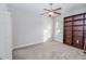 Bedroom with wall to wall carpet, a fan, a window, built in shelving and a white door at 543 Auburn Hill Blvd, Auburndale, FL 33823