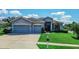 Charming single-story home with a well-manicured lawn and a three-car garage at 543 Auburn Hill Blvd, Auburndale, FL 33823