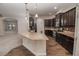 Gourmet kitchen with granite countertops, stainless steel appliances, and dark wood cabinetry at 543 Auburn Hill Blvd, Auburndale, FL 33823