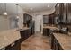 A well-appointed kitchen featuring granite countertops, dark wood cabinets, and stainless steel appliances at 543 Auburn Hill Blvd, Auburndale, FL 33823