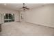 Open living room featuring sliding glass doors and neutral carpet and paint at 543 Auburn Hill Blvd, Auburndale, FL 33823