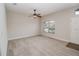 Comfortable living room with neutral carpet, a ceiling fan, and a window for natural light at 543 Auburn Hill Blvd, Auburndale, FL 33823