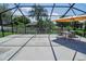 Covered patio with a dining table and chairs, patio furniture, privacy fence and a lush yard at 543 Auburn Hill Blvd, Auburndale, FL 33823