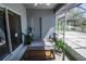 A screened in back patio with outdoor furniture and a view of the green backyard at 543 Auburn Hill Blvd, Auburndale, FL 33823