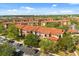 Aerial view of a community with lush landscaping and buildings with terracotta roofs at 5524 Metrowest Blvd # 210, Orlando, FL 32811