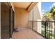 A cozy balcony with tiled flooring and a black metal railing provides a great place to relax at 5524 Metrowest Blvd # 210, Orlando, FL 32811