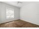This bedroom has neutral colored walls, a large window, and neutral carpet at 5524 Metrowest Blvd # 210, Orlando, FL 32811