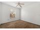 This bedroom features neutral colored carpet and walls, a ceiling fan, and a large window at 5524 Metrowest Blvd # 210, Orlando, FL 32811