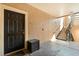 A condo entrance with a solid black door and staircase at 5524 Metrowest Blvd # 210, Orlando, FL 32811