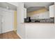 Bright kitchen view from the doorway with white cabinets and mosaic backsplash at 5524 Metrowest Blvd # 210, Orlando, FL 32811