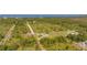Lush, sprawling property with a well-manicured lawn and proximity to a scenic body of water at 6273 Toronja Dr, Indian Lake Estates, FL 33855