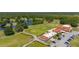 Beautiful golf course aerial view with verdant greens, a serene lake, and an elegant clubhouse at 6273 Toronja Dr, Indian Lake Estates, FL 33855