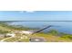 Breathtaking aerial view of the lake featuring a long pier, a community building and water views at 6273 Toronja Dr, Indian Lake Estates, FL 33855