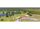 Scenic aerial of a golf course with manicured greens, a tranquil lake, and a well-appointed clubhouse at 6273 Toronja Dr, Indian Lake Estates, FL 33855