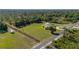 Secluded property boasts a well-kept lawn, mature trees, and a convenient circular driveway at 6273 Toronja Dr, Indian Lake Estates, FL 33855