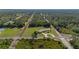 Serene property featuring a spacious lawn, mature trees, and easy access to surrounding nature at 6273 Toronja Dr, Indian Lake Estates, FL 33855