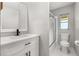 Bright bathroom features modern vanity, frameless shower and tiled floors, creating a fresh clean design at 6273 Toronja Dr, Indian Lake Estates, FL 33855