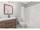Modern bathroom with new vanity, tiled floors, and shower with curtain, offering a fresh design at 6273 Toronja Dr, Indian Lake Estates, FL 33855
