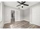 Cozy bedroom with wood-look floors, a ceiling fan, and a closet at 6273 Toronja Dr, Indian Lake Estates, FL 33855