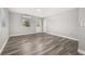 Bright bedroom featuring sleek gray flooring, a large window, and neutral wall color at 6273 Toronja Dr, Indian Lake Estates, FL 33855