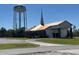 Quaint church building with a steeple beside the community water tower at 6273 Toronja Dr, Indian Lake Estates, FL 33855