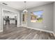Open dining area with wood-look floors, a view to the kitchen, and natural light at 6273 Toronja Dr, Indian Lake Estates, FL 33855