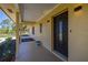 Inviting entryway showcasing a stylish front door, tiled porch and manicured landscaping at 6273 Toronja Dr, Indian Lake Estates, FL 33855