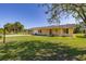 Lovely single Gathering home with a covered porch and an attached garage at 6273 Toronja Dr, Indian Lake Estates, FL 33855