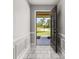 Bright foyer featuring tiled floors, decorative molding, and an open view to the outdoors at 6273 Toronja Dr, Indian Lake Estates, FL 33855