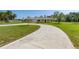 Charming single Gathering home featuring a long drive and beautiful landscaping at 6273 Toronja Dr, Indian Lake Estates, FL 33855
