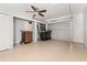 Spacious garage with ample storage, a ceiling fan, and room for multiple vehicles at 6273 Toronja Dr, Indian Lake Estates, FL 33855