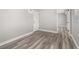 Hallway with wood-look floors, a white door, and access to other rooms at 6273 Toronja Dr, Indian Lake Estates, FL 33855