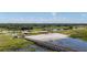 Scenic view of the community's lake access with sandy beach and boat ramp, perfect for water activities at 6273 Toronja Dr, Indian Lake Estates, FL 33855