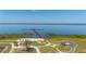 Beautiful aerial view of a lake with a pier, community area and landscaped grounds, ideal for tranquil lakeside living at 6273 Toronja Dr, Indian Lake Estates, FL 33855