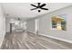 Open-concept living room flows into the kitchen and features natural light and wood-look flooring at 6273 Toronja Dr, Indian Lake Estates, FL 33855