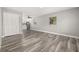 Open living space with wood-look floors, natural light, and views of the kitchen at 6273 Toronja Dr, Indian Lake Estates, FL 33855
