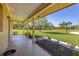 Lovely porch area with a nice decorative flower bed and views of lawn at 6273 Toronja Dr, Indian Lake Estates, FL 33855