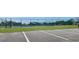 Well-maintained tennis courts enclosed by fencing, with players engaged in a match, promoting an active lifestyle at 6273 Toronja Dr, Indian Lake Estates, FL 33855
