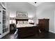 Comfortable bedroom with dark wood furniture, plush bedding and nice lamps at 700 Bear Shadow Ct, Longwood, FL 32779