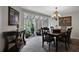 Elegant dining room with a chandelier, large windows, and access to a sunroom at 700 Bear Shadow Ct, Longwood, FL 32779