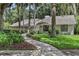 Charming single-story home featuring lush landscaping, a stone facade, and a welcoming walkway at 700 Bear Shadow Ct, Longwood, FL 32779