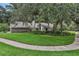Sprawling front lawn with mature trees and landscaping, showcasing the home's curb appeal at 700 Bear Shadow Ct, Longwood, FL 32779
