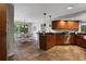 Well-equipped kitchen with wood cabinets, stainless steel appliances, and adjacent dining area at 700 Bear Shadow Ct, Longwood, FL 32779