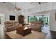 Bright living room featuring hardwood floors, high ceilings, and comfortable leather seating at 700 Bear Shadow Ct, Longwood, FL 32779